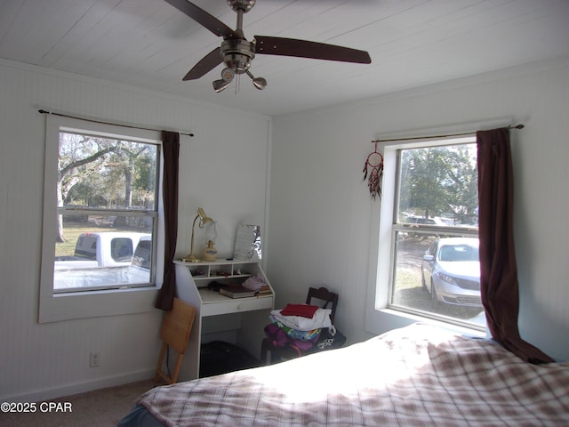 bedroom featuring ceiling fan, carpet, crown molding, and multiple windows