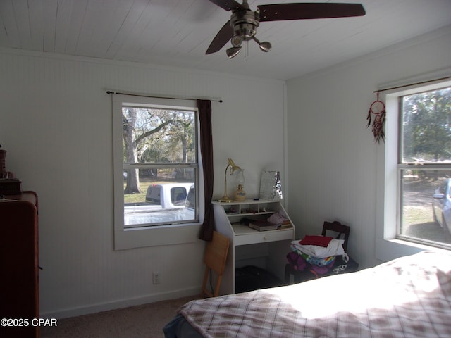 bedroom featuring ceiling fan, multiple windows, ornamental molding, and carpet flooring