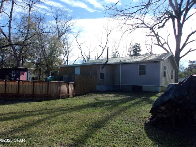 back of property featuring a lawn