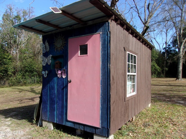 view of outbuilding with a lawn