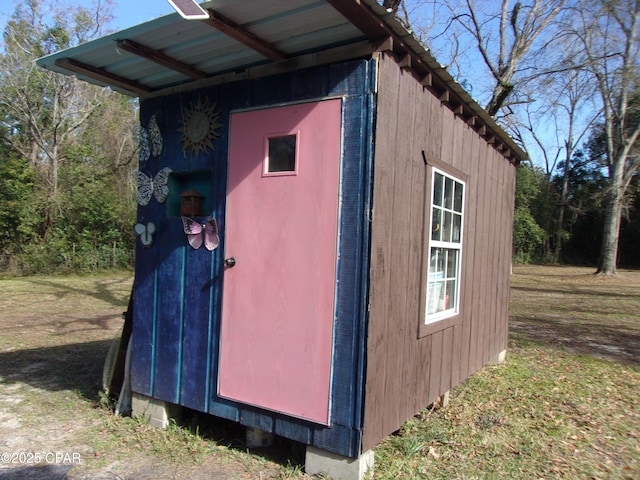 view of outdoor structure featuring a lawn