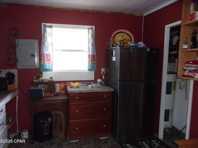 kitchen with electric panel, ornamental molding, and fridge