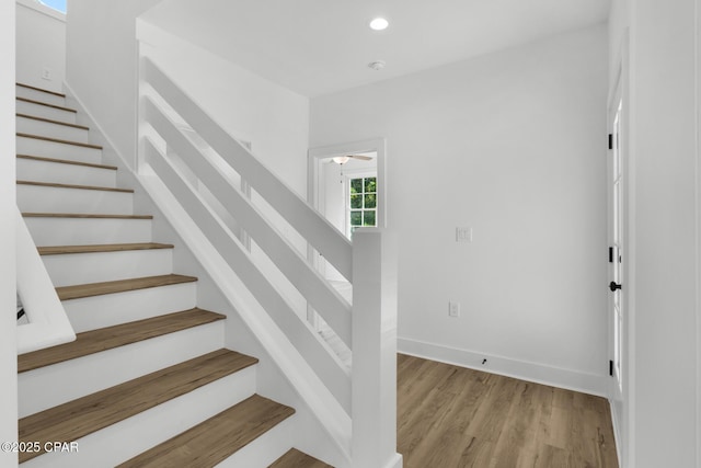 stairs with hardwood / wood-style floors