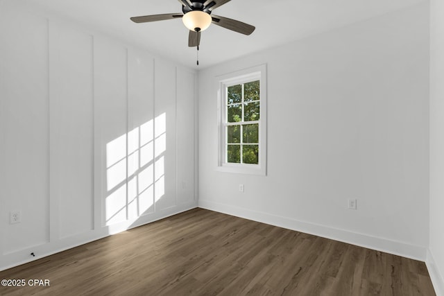 spare room with ceiling fan and dark hardwood / wood-style flooring