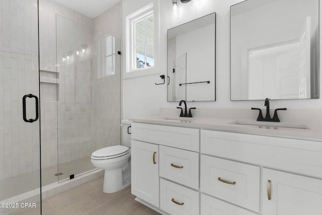 bathroom with a shower with shower door, vanity, and toilet