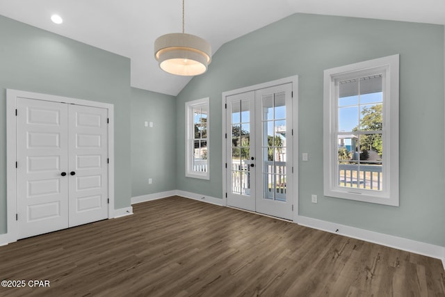 doorway to outside with dark hardwood / wood-style floors, lofted ceiling, and french doors