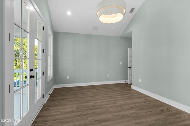 foyer featuring vaulted ceiling, dark hardwood / wood-style flooring, and french doors