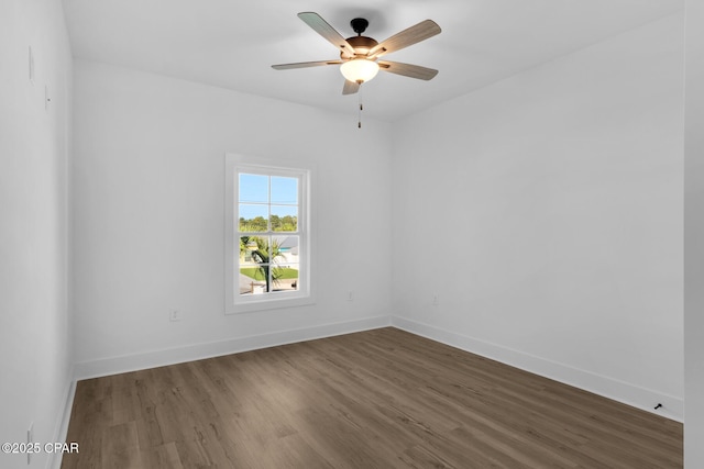 spare room featuring ceiling fan and dark hardwood / wood-style floors