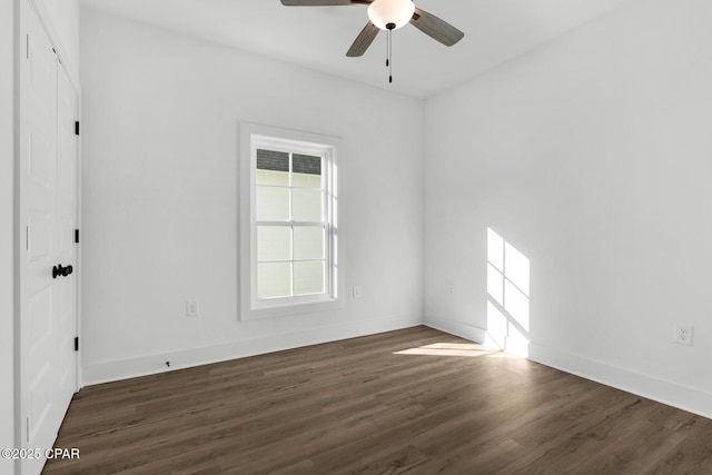 spare room featuring dark wood-type flooring and ceiling fan