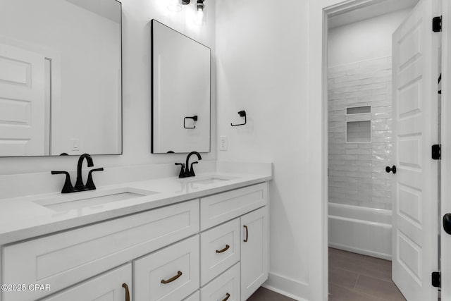 bathroom featuring tiled shower / bath and vanity