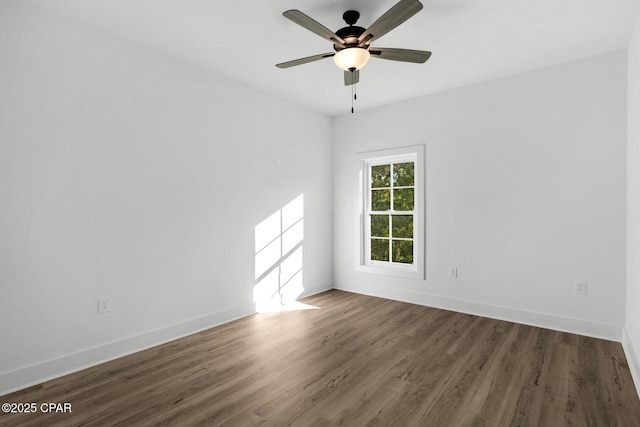 spare room with ceiling fan and dark hardwood / wood-style floors