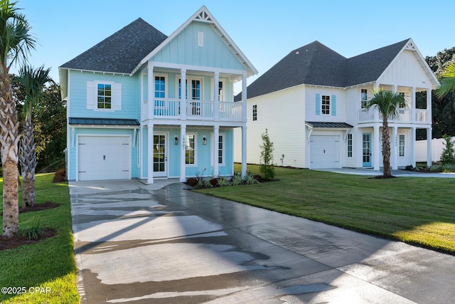 view of front of house featuring a front yard, a garage, and a balcony