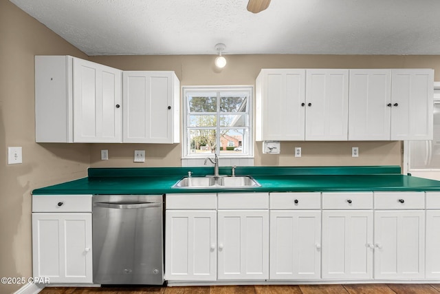 kitchen featuring sink, white cabinetry, stainless steel dishwasher, and a textured ceiling