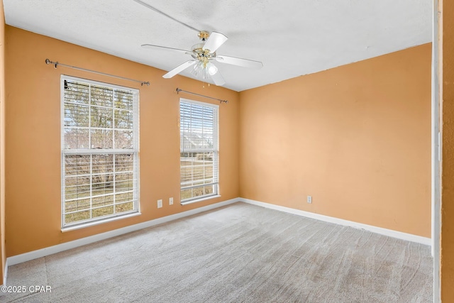 spare room with carpet, ceiling fan, and a textured ceiling