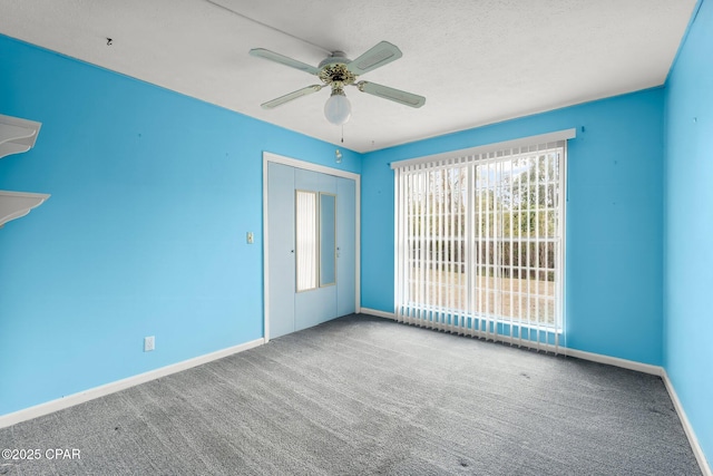 empty room with carpet floors and ceiling fan