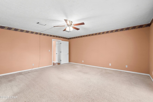 empty room featuring carpet floors and ceiling fan