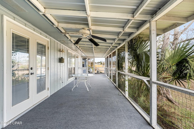 unfurnished sunroom with ceiling fan and french doors