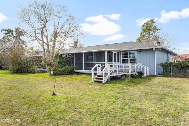 view of front of home with a front lawn, a wooden deck, and a sunroom