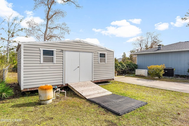 view of outbuilding with a yard and central AC