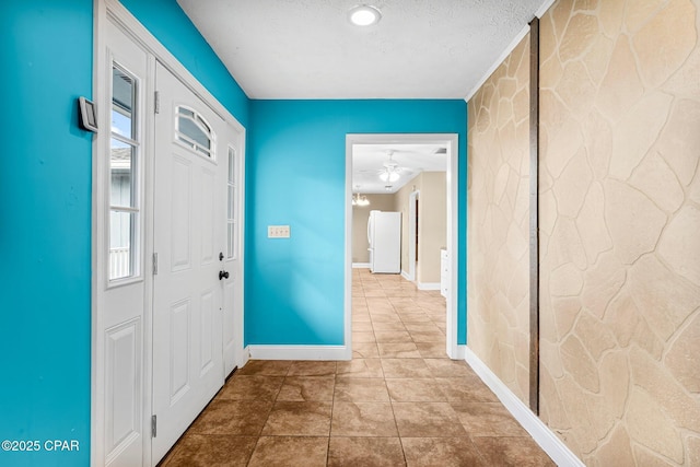 entrance foyer featuring ceiling fan and a textured ceiling