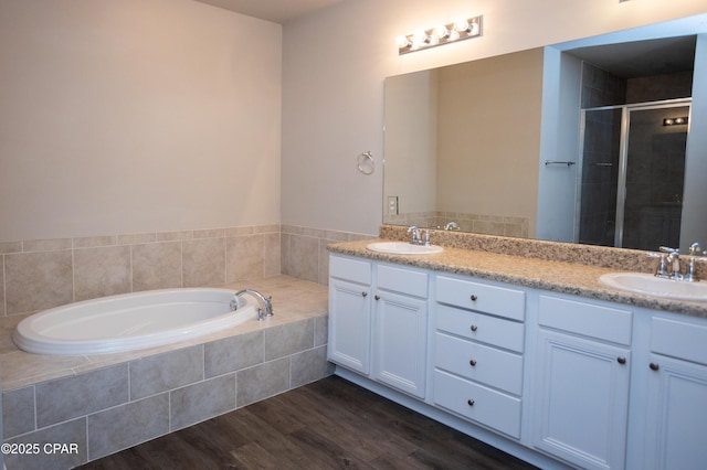 bathroom featuring vanity, hardwood / wood-style flooring, and shower with separate bathtub