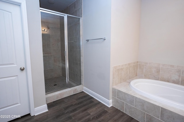 bathroom with separate shower and tub and hardwood / wood-style floors