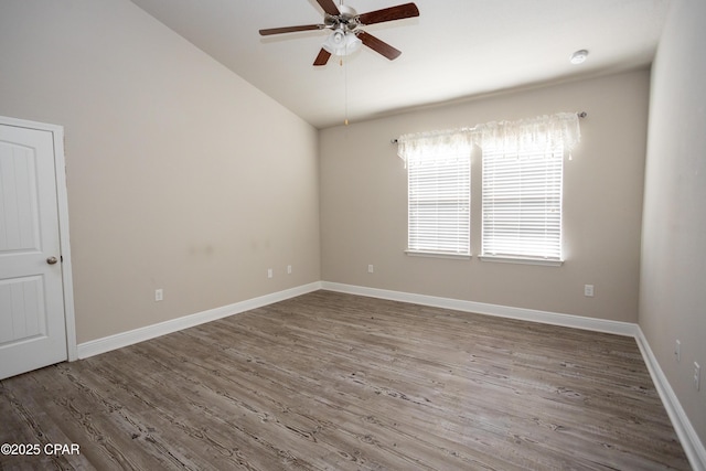 spare room featuring ceiling fan, lofted ceiling, and hardwood / wood-style flooring