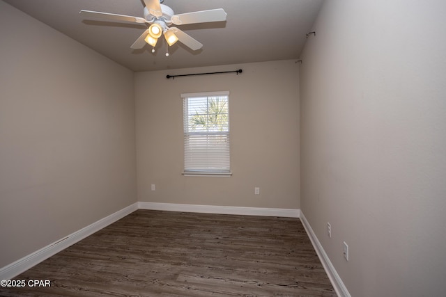 spare room featuring dark hardwood / wood-style floors and ceiling fan