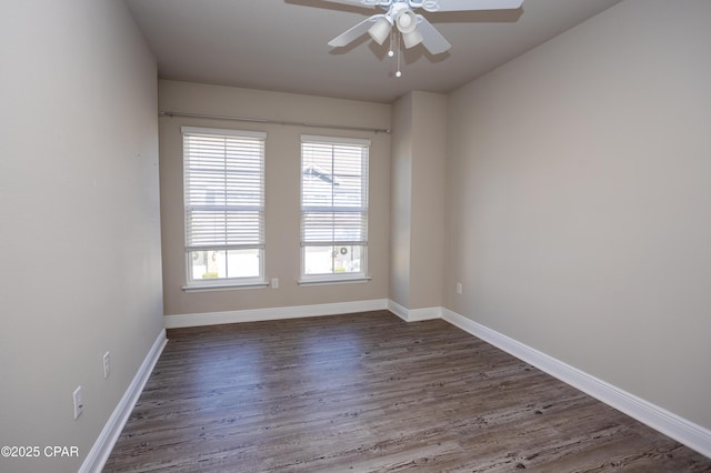 spare room featuring dark hardwood / wood-style floors and ceiling fan