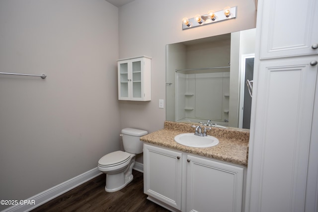bathroom with a shower, wood-type flooring, vanity, and toilet