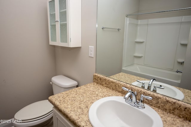 full bathroom featuring vanity, toilet, and washtub / shower combination