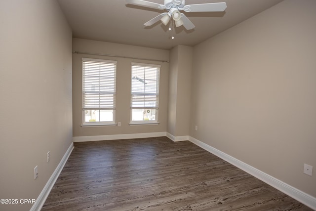 spare room featuring ceiling fan and dark wood-type flooring