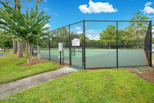 view of sport court with a yard