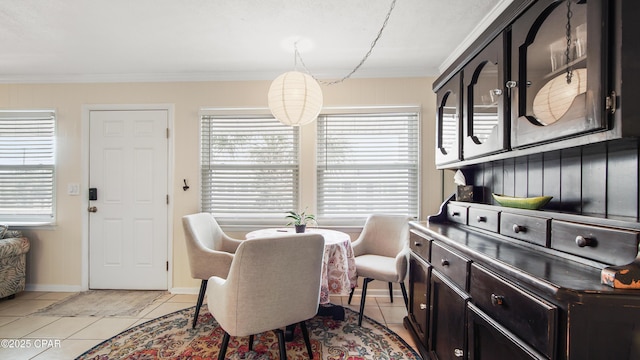 dining area with crown molding and light tile patterned flooring