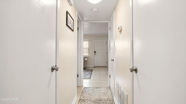 corridor featuring light tile patterned floors