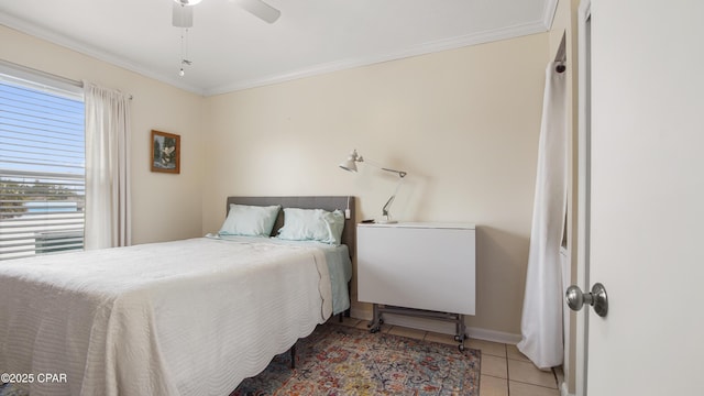 tiled bedroom with ornamental molding and ceiling fan