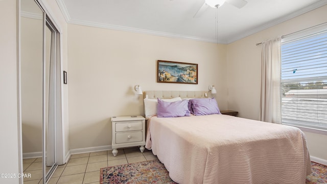 tiled bedroom featuring crown molding, ceiling fan, and a closet