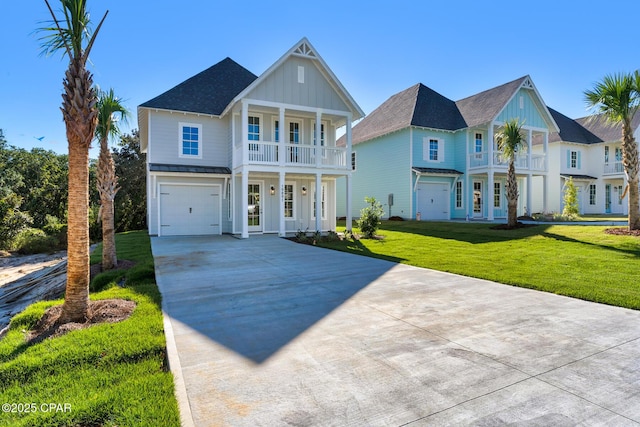 view of front of house featuring a front yard, a balcony, and a garage