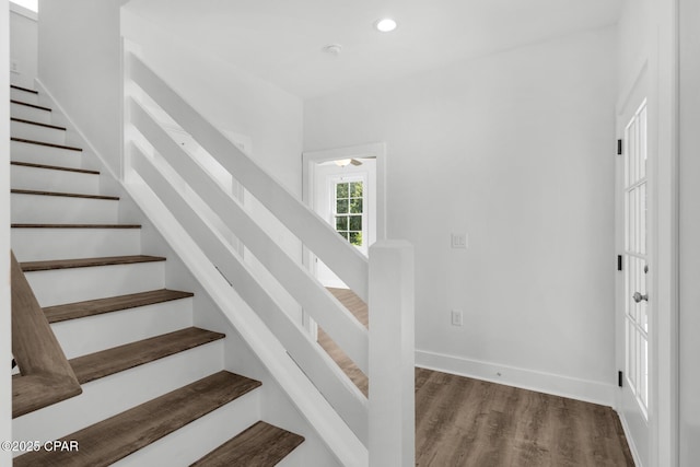 stairs featuring wood-type flooring