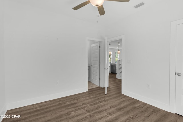 spare room with ceiling fan and dark wood-type flooring