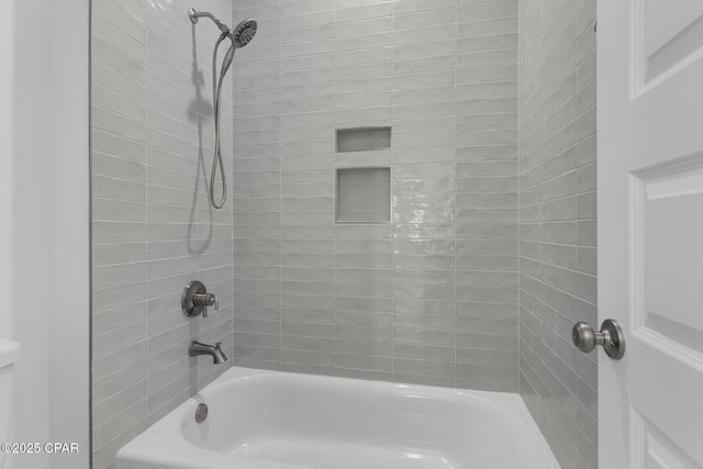 bathroom featuring tiled shower / bath