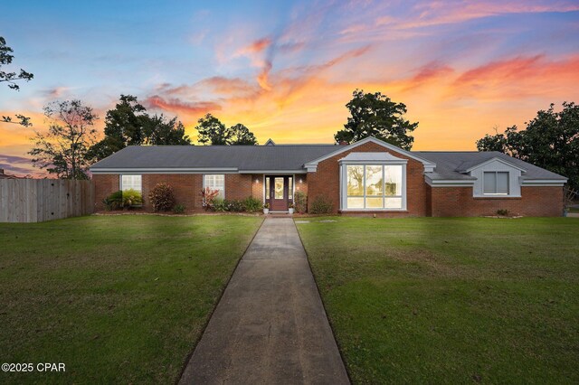 ranch-style house with a lawn