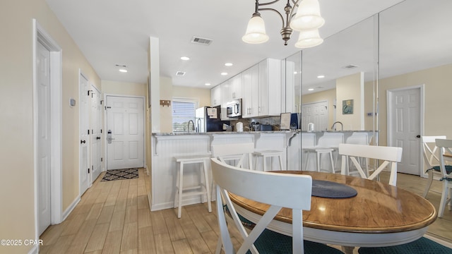 dining space featuring light wood-type flooring