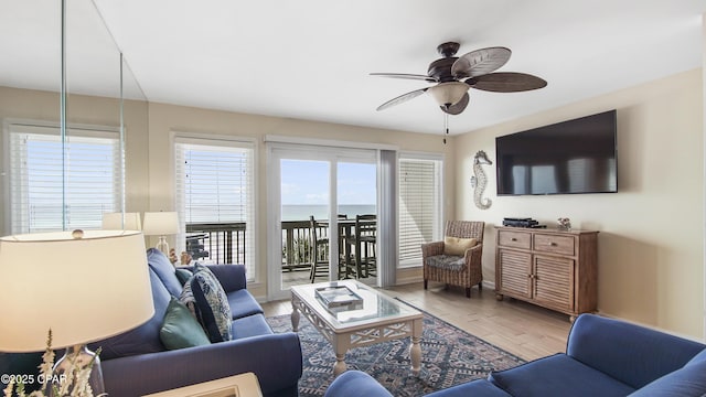 living room with light hardwood / wood-style flooring and ceiling fan