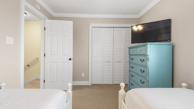 bedroom featuring crown molding, light colored carpet, and a closet