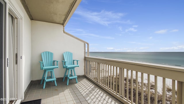 balcony featuring a water view and a view of the beach