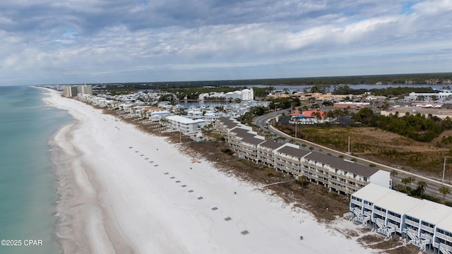 birds eye view of property featuring a beach view and a water view