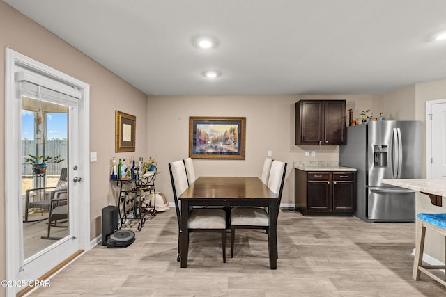 dining space with light hardwood / wood-style floors