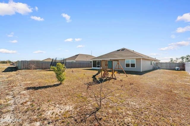 back of house featuring a playground