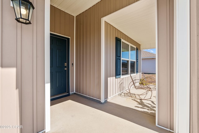 view of exterior entry with a porch